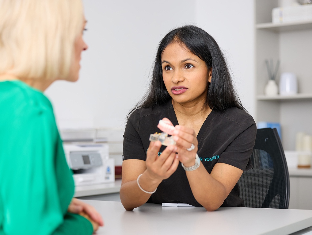 Dr Yoganathan gives advice to client | dental implants Sydney