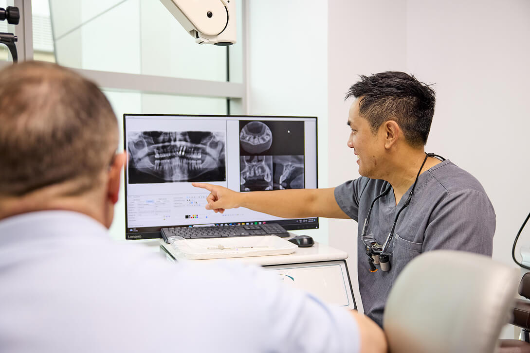 dentist analysing teeth xray | Endodontist Clinic Sydney